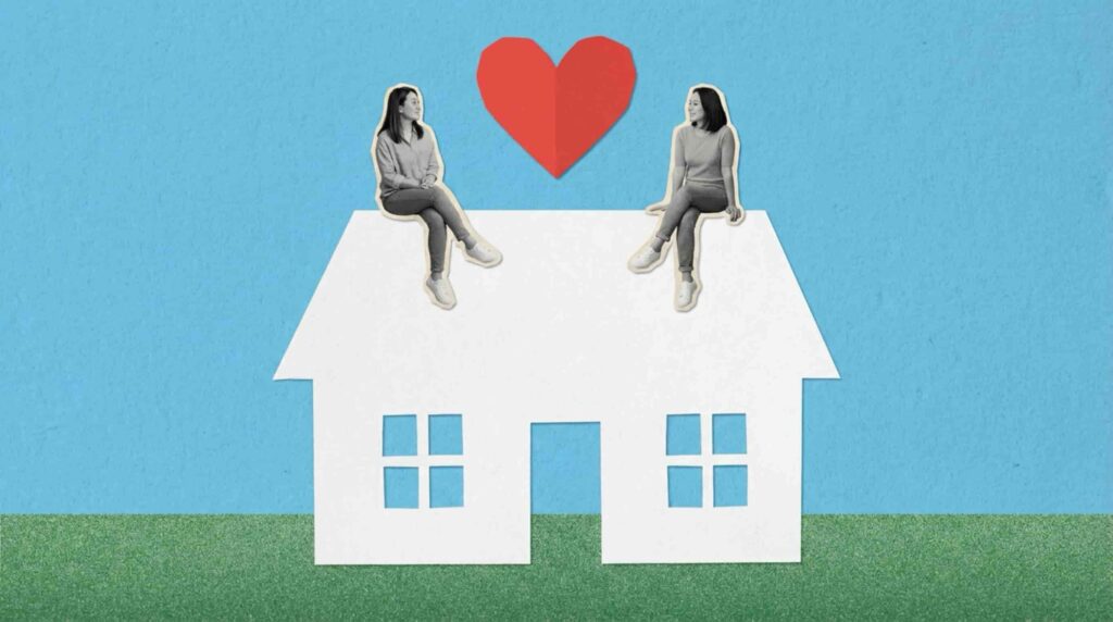 A couple sitting on a paper house